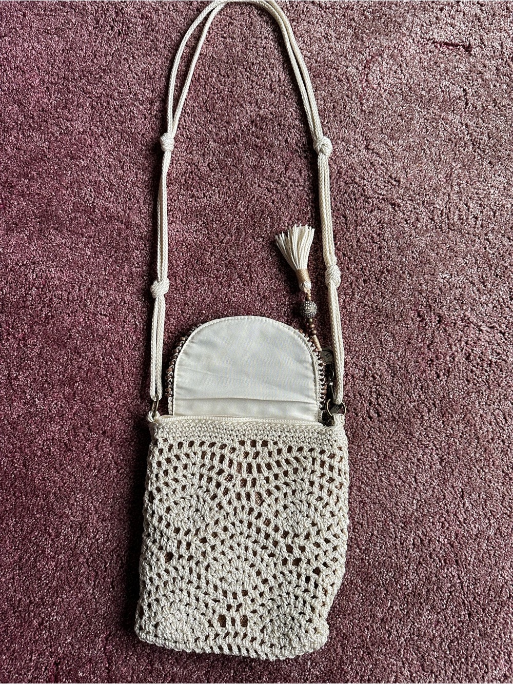 The Sak Cream Crochet Crossbody Bag with Tassel. Used 1 time. Size is 8x9.